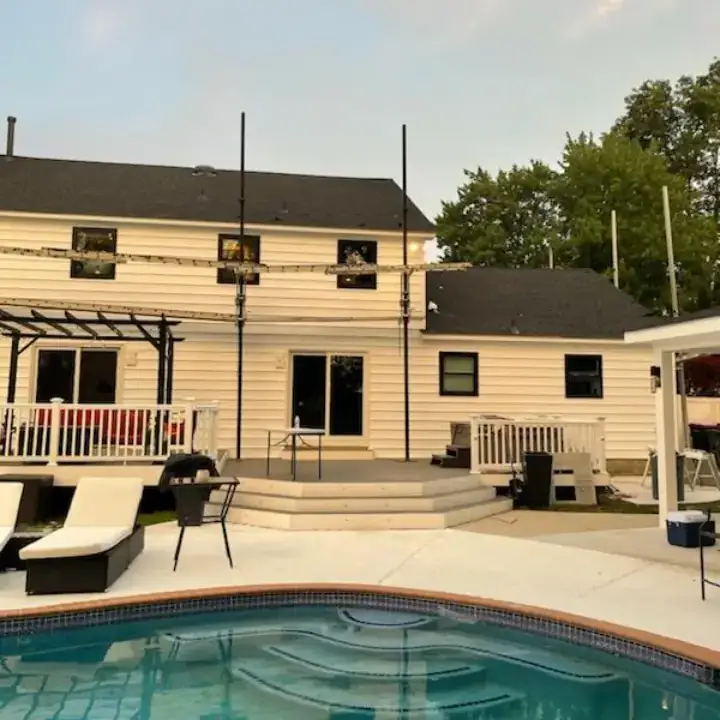 House with backyard pool and lounge area.