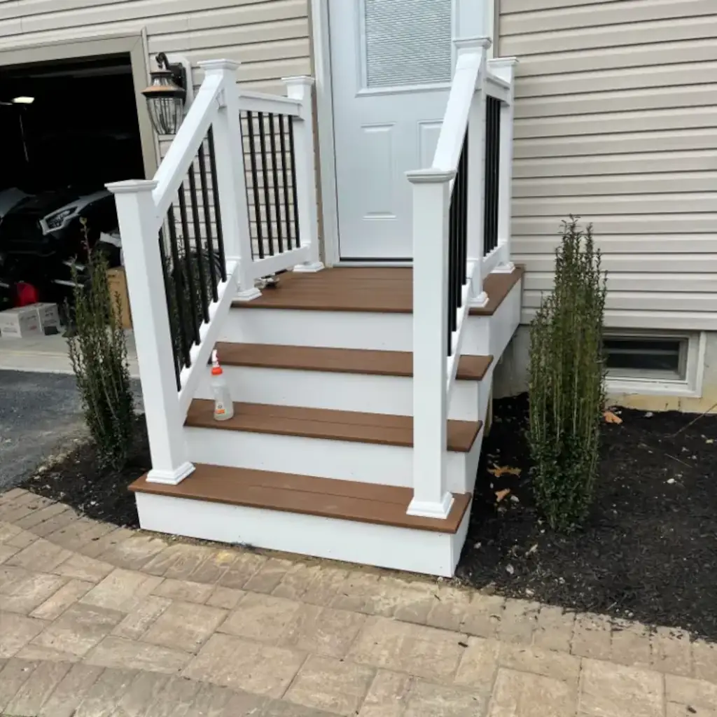 White steps with brown treads and black balusters.