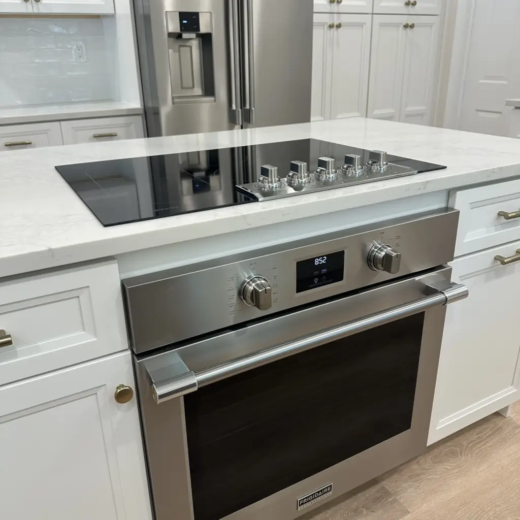 Modern kitchen with stainless steel oven and stovetop.