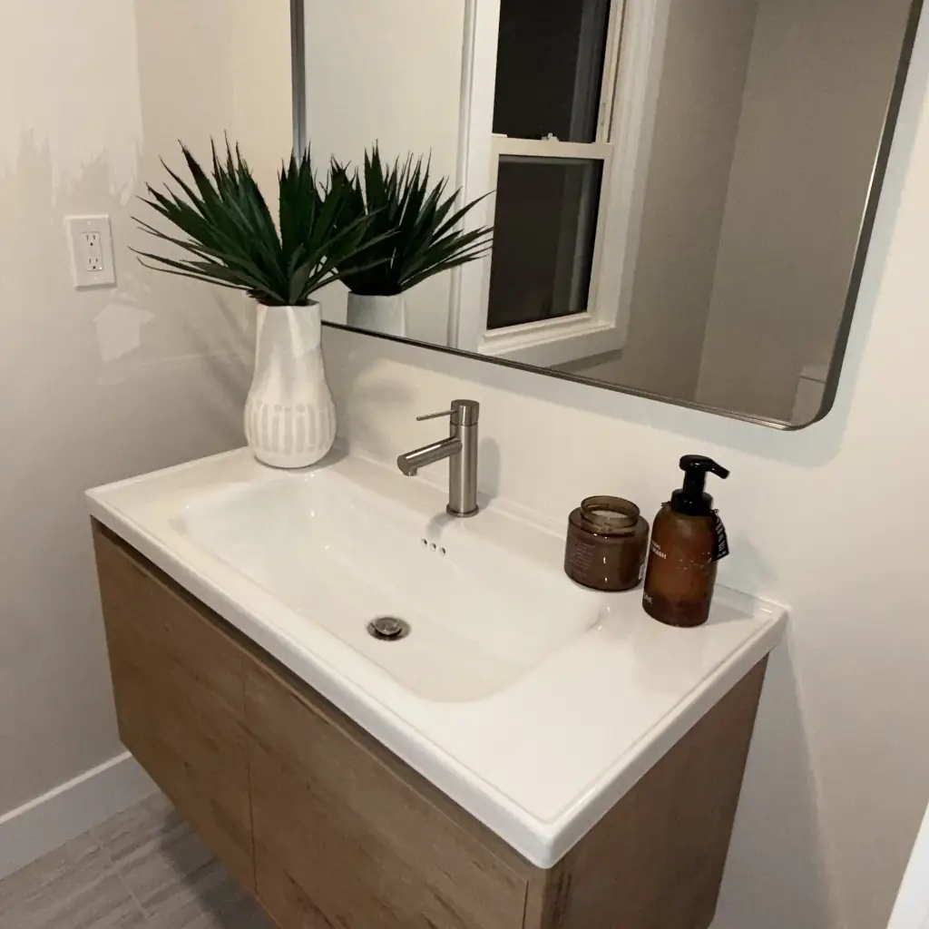 Modern bathroom sink with mirror and window.