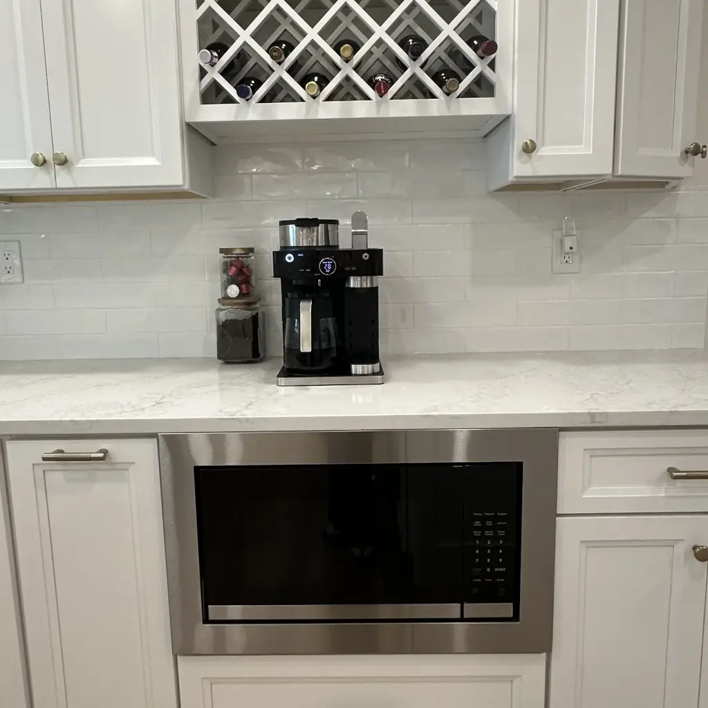 Modern kitchen with coffee maker and microwave.