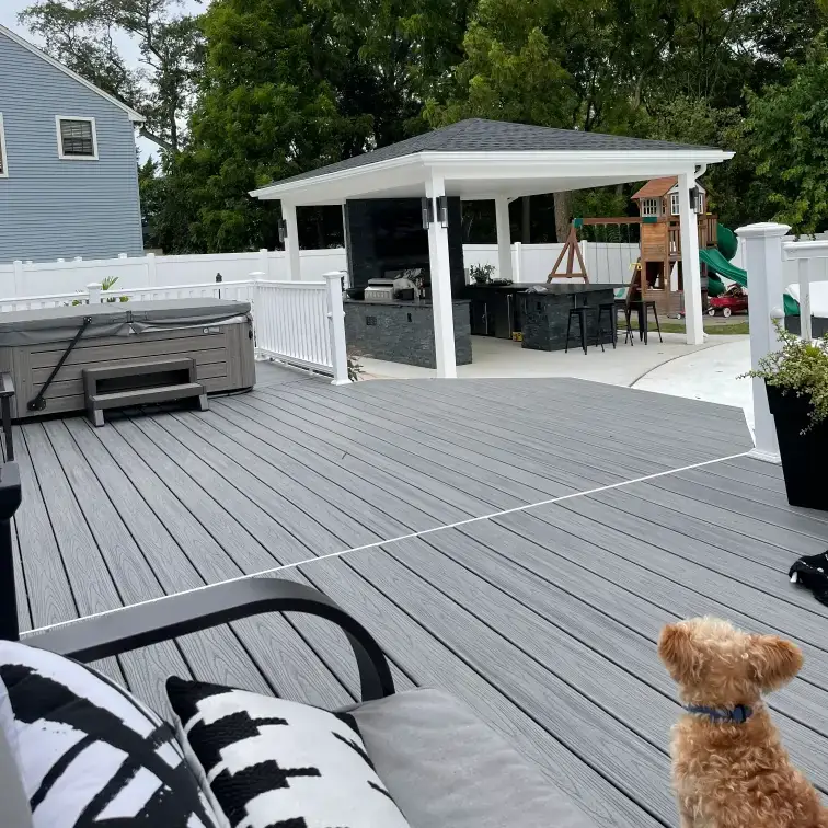 Backyard deck with hot tub and gazebo.